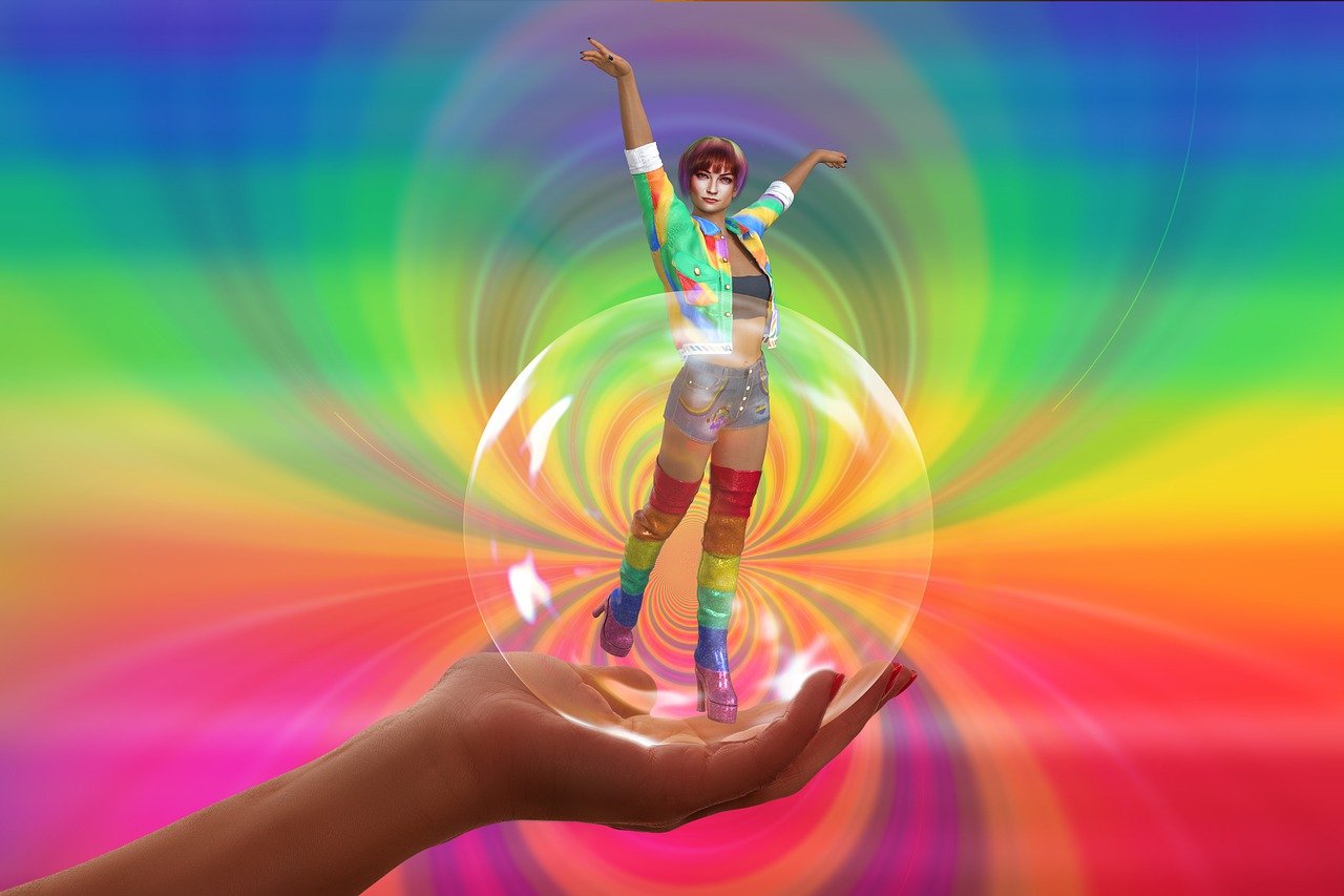Der Hintergrund ist in leuchtenden Regenbogen Farben gestaltet. Links in Bd ragt eine geöffnete Hand worauf eine transpartente Kugel liegt. Dieser Kugel entspringt in einem Wirbel ein Mensch, der seitlich die Arme hochreckt.